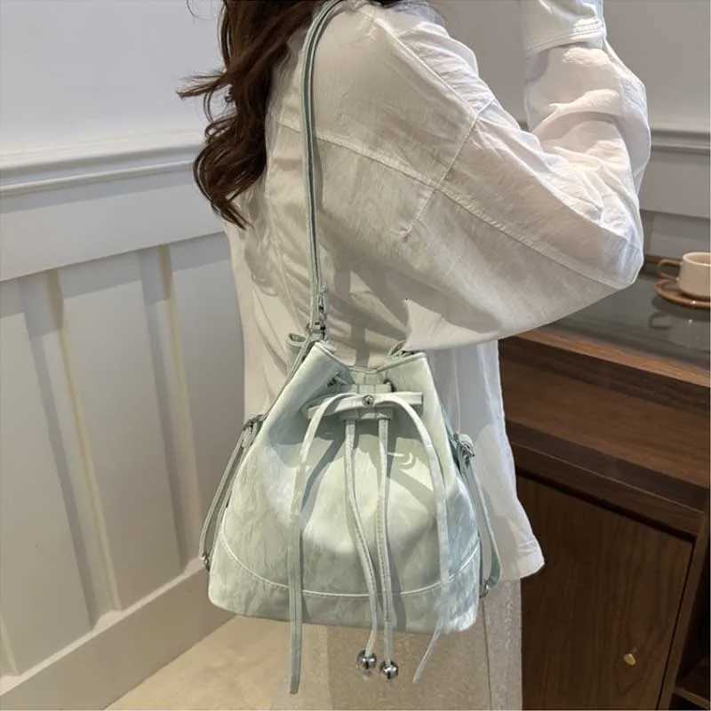Trend Womens Crossbody Bucket Bag String Design High Quality S Size Versatile Autumn Fashion Korean Leisure Handbag Backpacks XJ250814