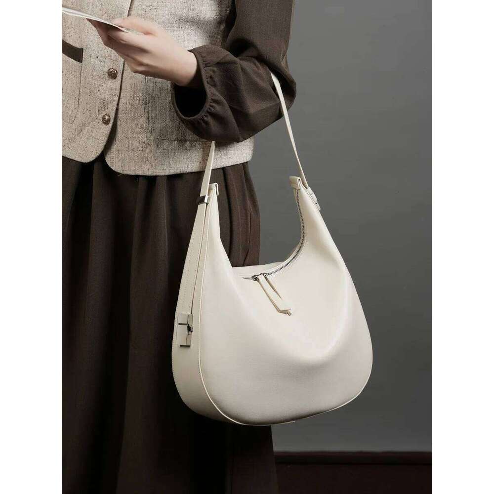 2025 spring/summer new niche design cowhide underarm shoulder hand-held leather crescent bucket women's bag