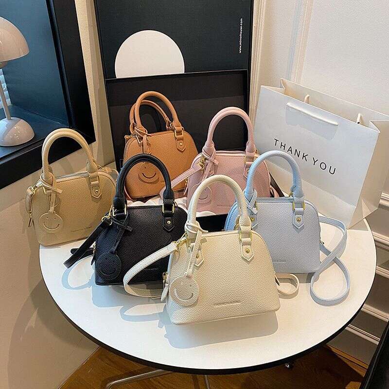Trendy temperament solid color hand-held shell 2024 new high-end multi-color single shoulder crossbody women's bag