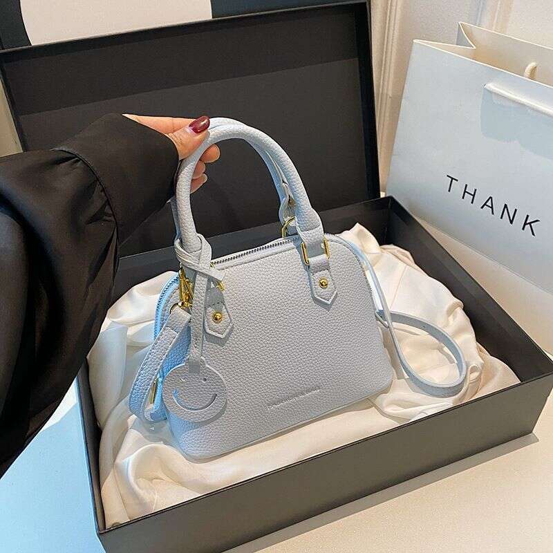Trendy temperament solid color hand-held shell 2024 new high-end multi-color single shoulder crossbody women's bag
