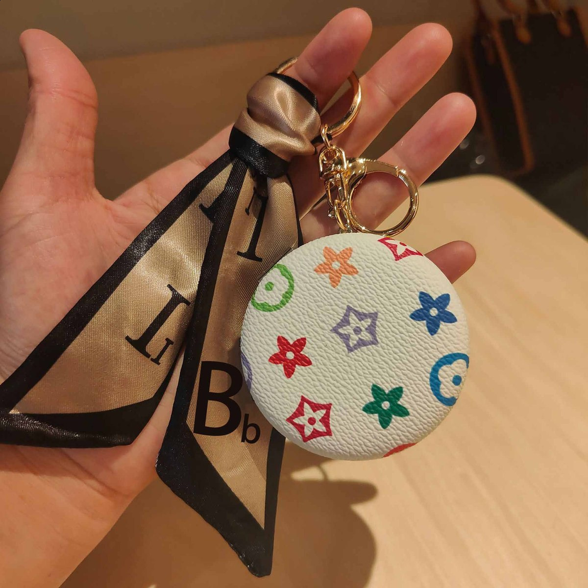 Designer car keychain pendant decorations, mini portable makeup mirrors, and bag accessories 250818