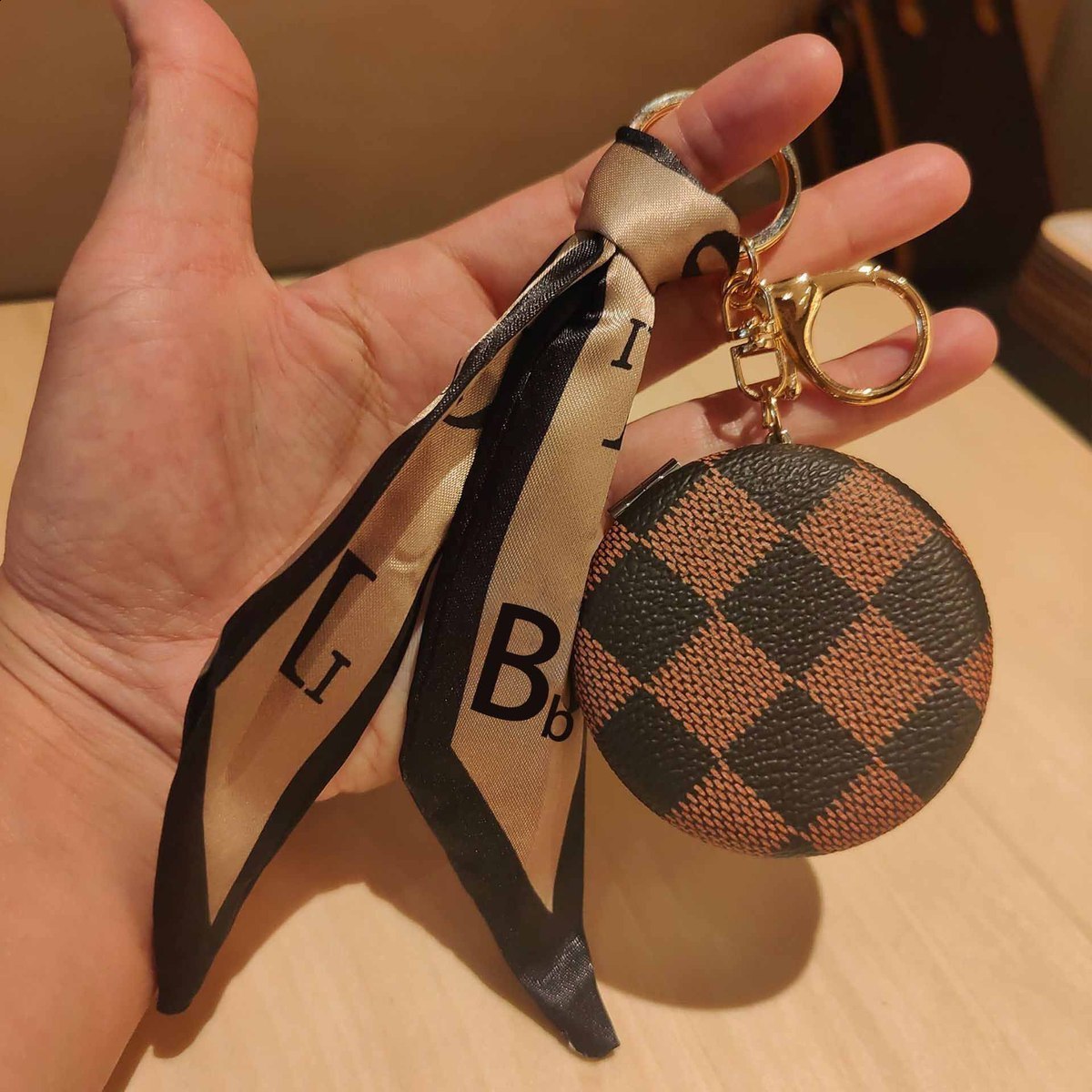 Designer car keychain pendant decorations, mini portable makeup mirrors, and bag accessories 250818