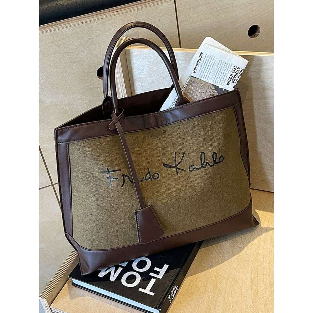 A niche designer canvas tote for women's 2024 new high-capacity commuting handheld shoulder bag
