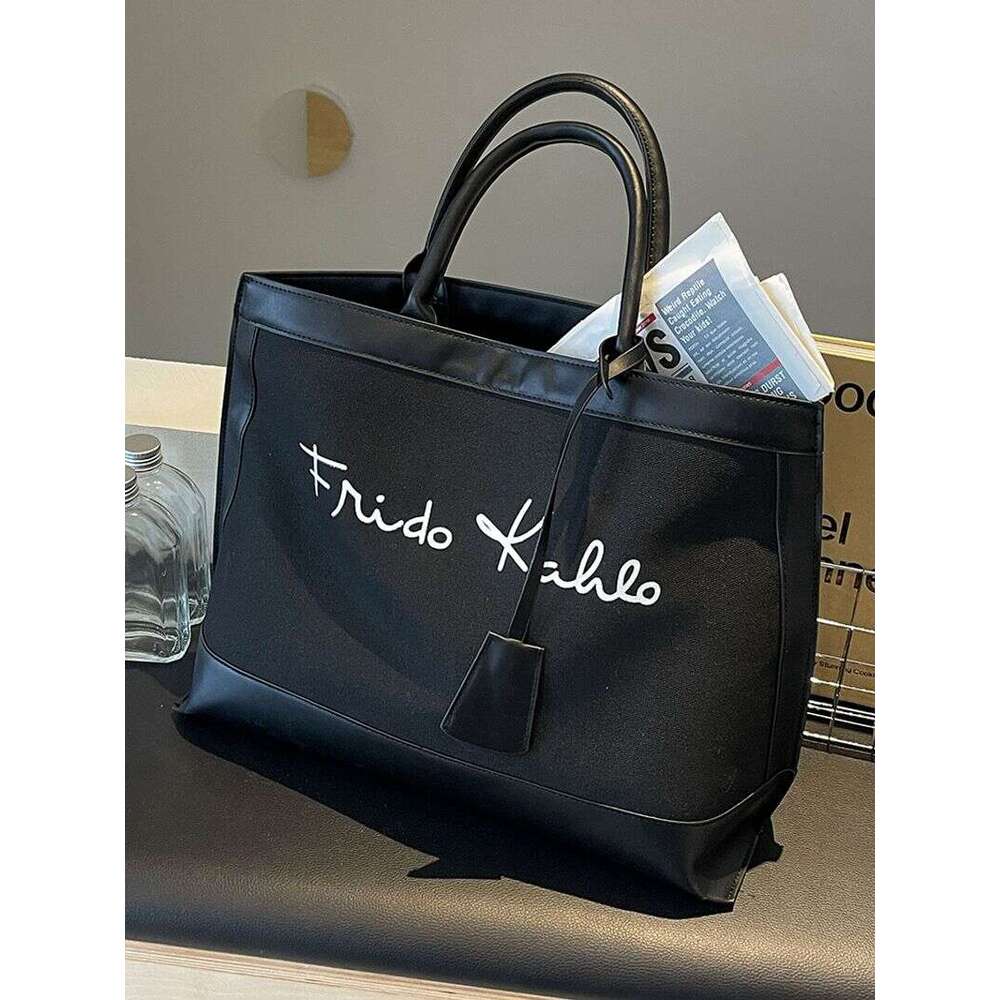 A niche designer canvas tote for women's 2024 new high-capacity commuting handheld shoulder bag