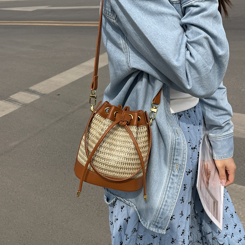 Free shipping designer Straw Woven Women Bag Summer New Niche Design Fashion Retro Rattan Drawstring Bucket Bag Versatile Crossbody Bag