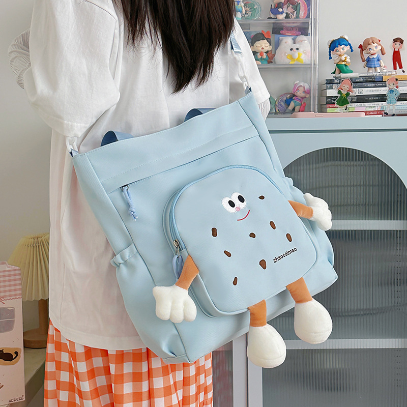 2025 Autumn Cute Canvas Bag Biscuit Biscuit Crossbody Bag Design Shiny Nylon Shoulder Bag Large Capacity Bag Women's Crossbody Bag Designer Bag W