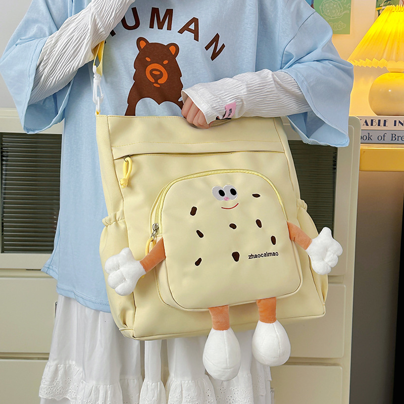 2025 Autumn Cute Canvas Bag Biscuit Biscuit Crossbody Bag Design Shiny Nylon Shoulder Bag Large Capacity Bag Women's Crossbody Bag Designer Bag W