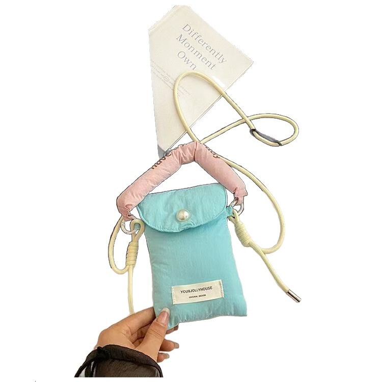 2025 autumn new minimalist style mobile phone storage bag Korean style women's slanted small bag handheld cloth bag women's mobile phone bag