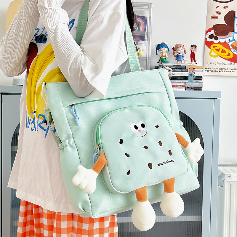 2025 Autumn Cute Canvas Bag Biscuit Biscuit Crossbody Bag Design Shiny Nylon Shoulder Bag Large Capacity Bag Women's Crossbody Bag Designer Bag W