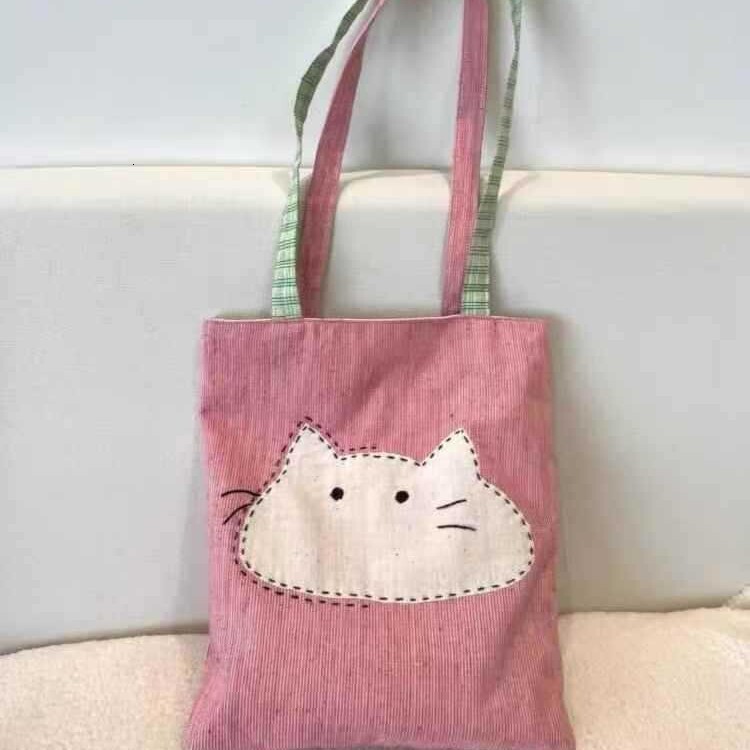 2025 autumn new Japanese style shoulder bag lightweight, niche, simple canvas women's bag cute cartoon bag cat head pink shoulder bag designer ca