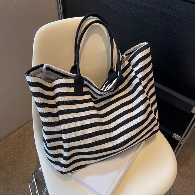 2025 autumn new canvas bag, fashionable commuting bag, simple and niche design, women's large bag capacity handbag, striped designer shoulder bag