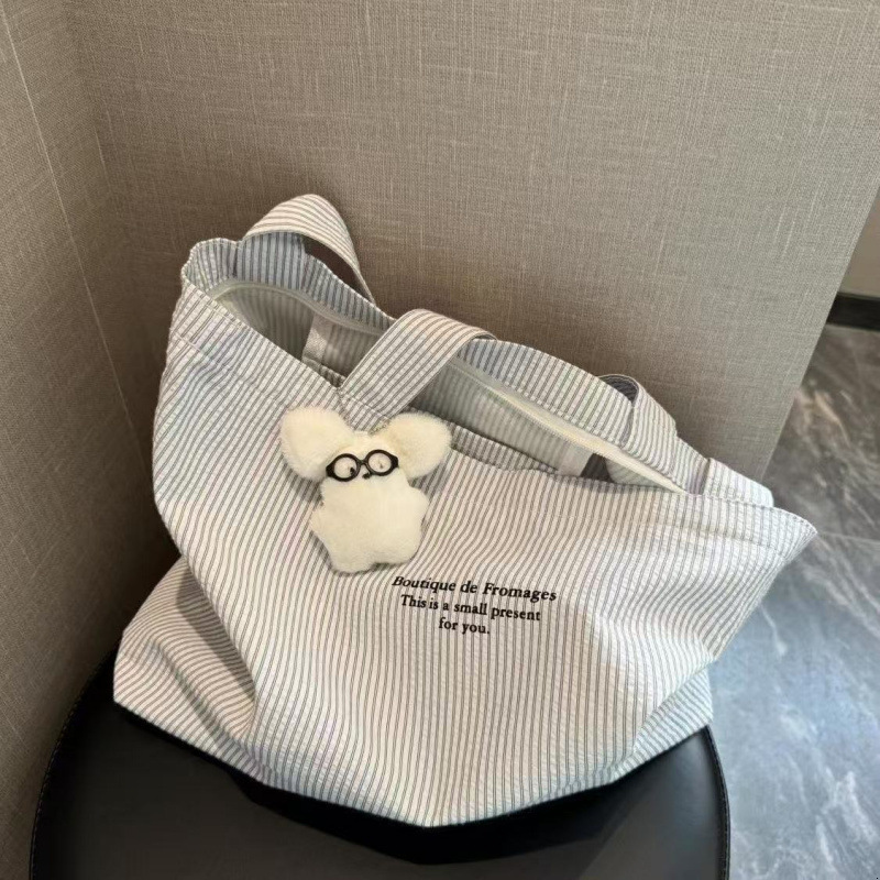 2025 autumn new casual striped lazy simple, lightweight, atmospheric, compact, large capacity, niche design, commuting canvas bag, bag designer should
