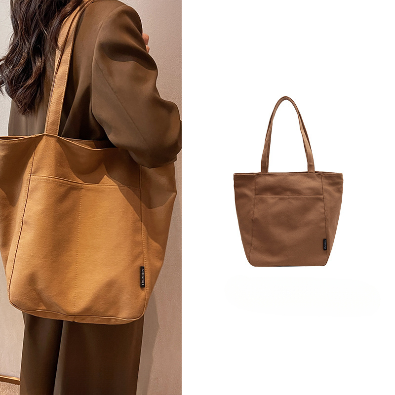 2025 autumn new women's canvas bag with large capacity, simple and bag niche design, commuting handbag, student shoulder bag, designer canvas bag