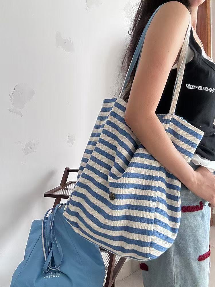 2025 autumn new double-sided striped canvas bag bag niche simple Korean style double-sided usable lazy style handbag designer shoulder bag women'