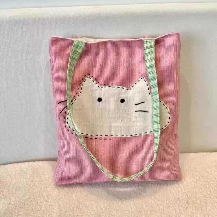 2025 autumn new Japanese style shoulder bag lightweight, niche, simple canvas women's bag cute cartoon bag cat head pink shoulder bag designer ca