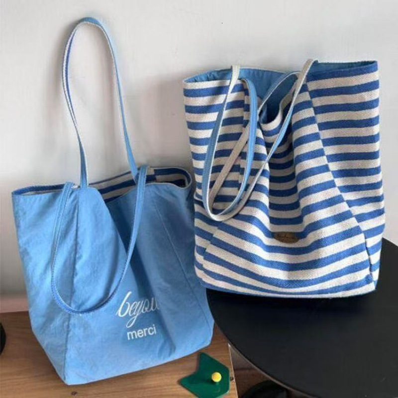 2025 autumn new double-sided striped canvas bag bag niche simple Korean style double-sided usable lazy style handbag designer shoulder bag women'