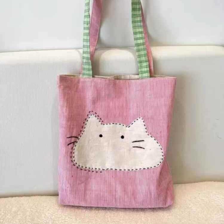 2025 autumn new Japanese style shoulder bag lightweight, niche, simple canvas women's bag cute cartoon bag cat head pink shoulder bag designer ca