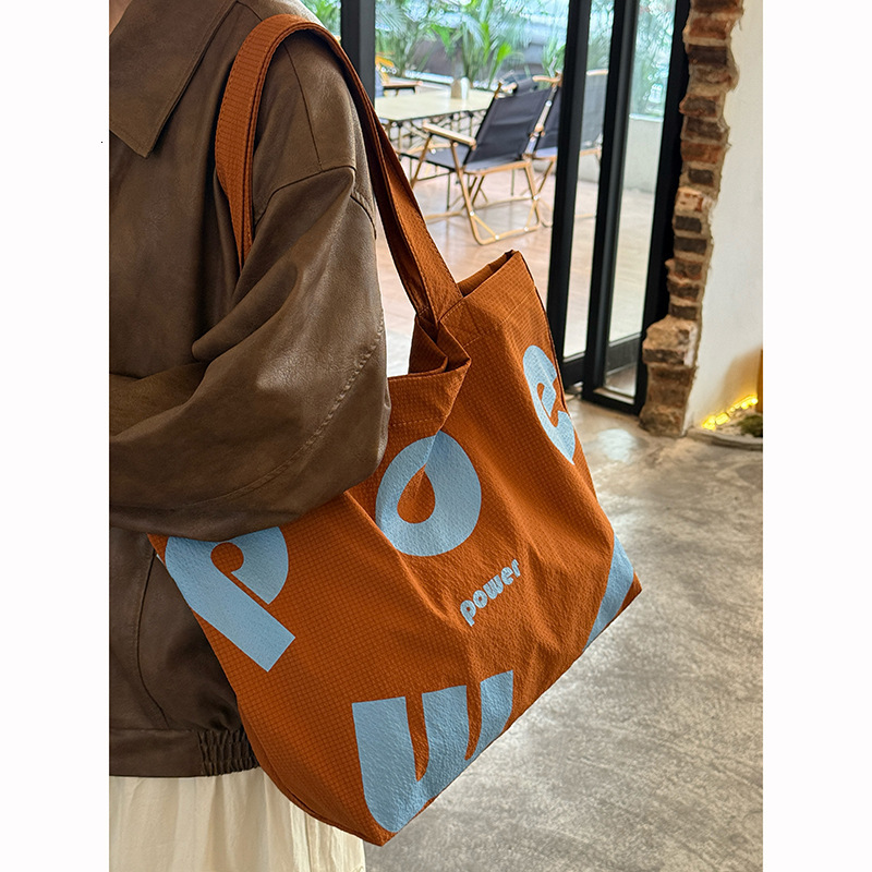 2025 Autumn New Korean Letter Drawstring Design Simple, Small, bag Lightweight, Large Capacity Casual Shoulder Designer Shoulder Bag Women's Canv
