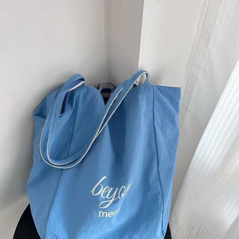 2025 autumn new double-sided striped canvas bag bag niche simple Korean style double-sided usable lazy style handbag designer shoulder bag women'