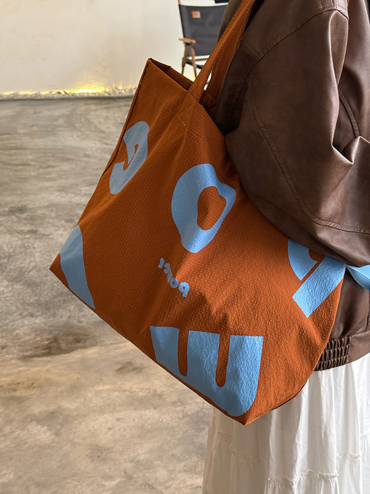 2025 Autumn New Korean Letter Drawstring Design Simple, Small, bag Lightweight, Large Capacity Casual Shoulder Designer Shoulder Bag Women's Canv