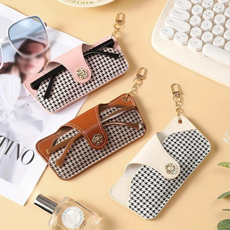 A stylish and minimalist PU leather glasses case with a chain for easy carrying and protection 250821