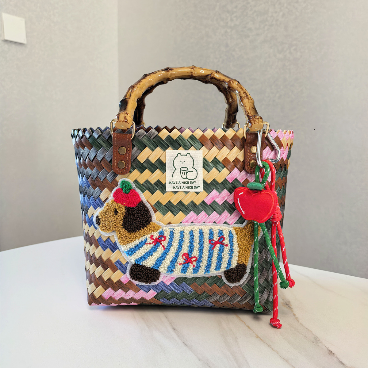2025 autumn new retro striped sausage dog woven bag bag with simple and niche design, nylon rope pendant, women's handbag designer beach bag
