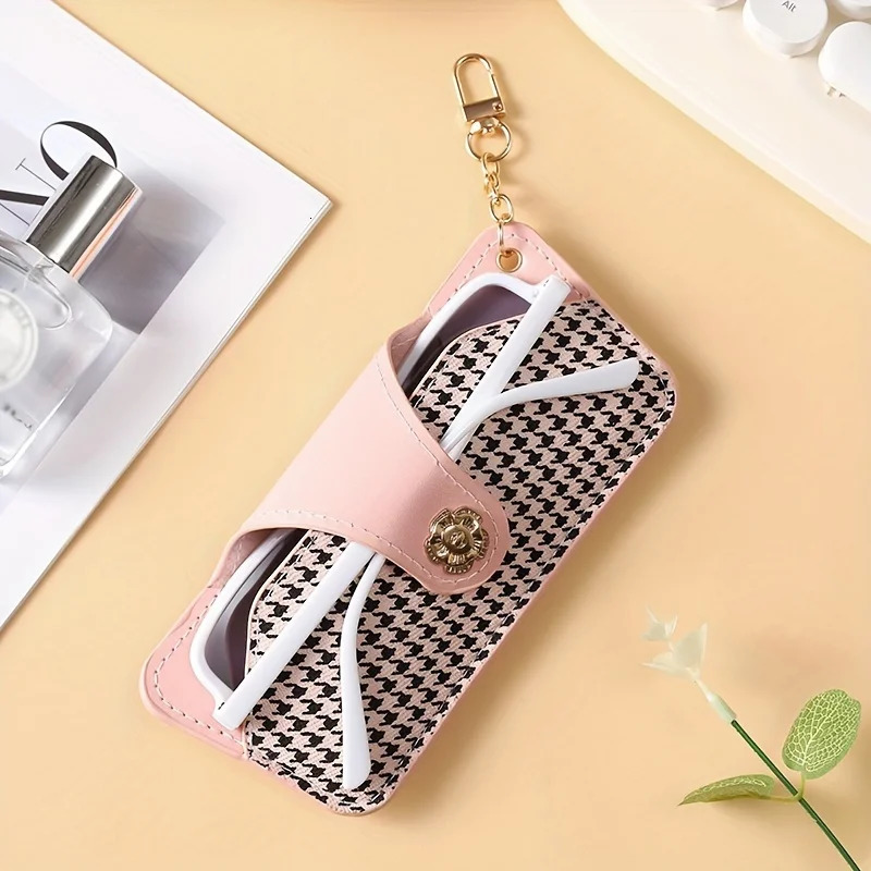 A stylish and minimalist PU leather glasses case with a chain for easy carrying and protection 250821
