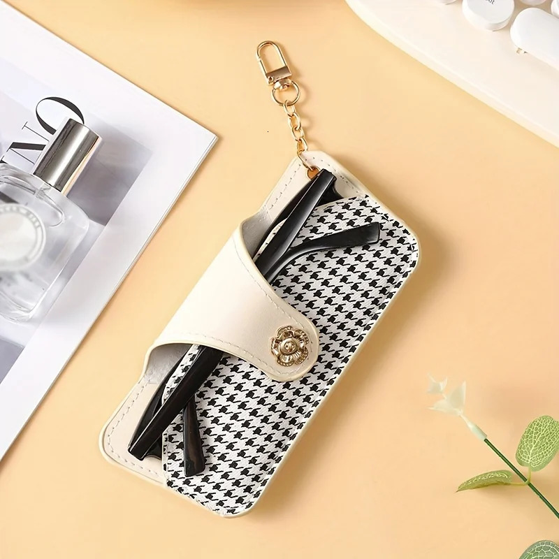 A stylish and minimalist PU leather glasses case with a chain for easy carrying and protection 250821