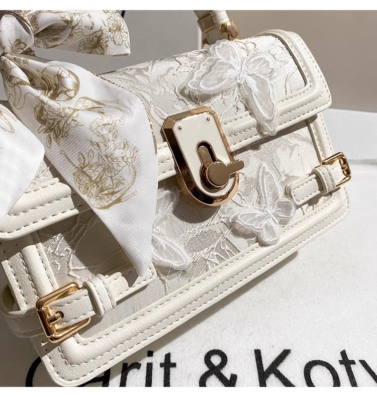 This handbag features intricate embossing and a chic striped ribbon Its gold clasp adds luxury Ideal for daily parties or banquets a global fashion st