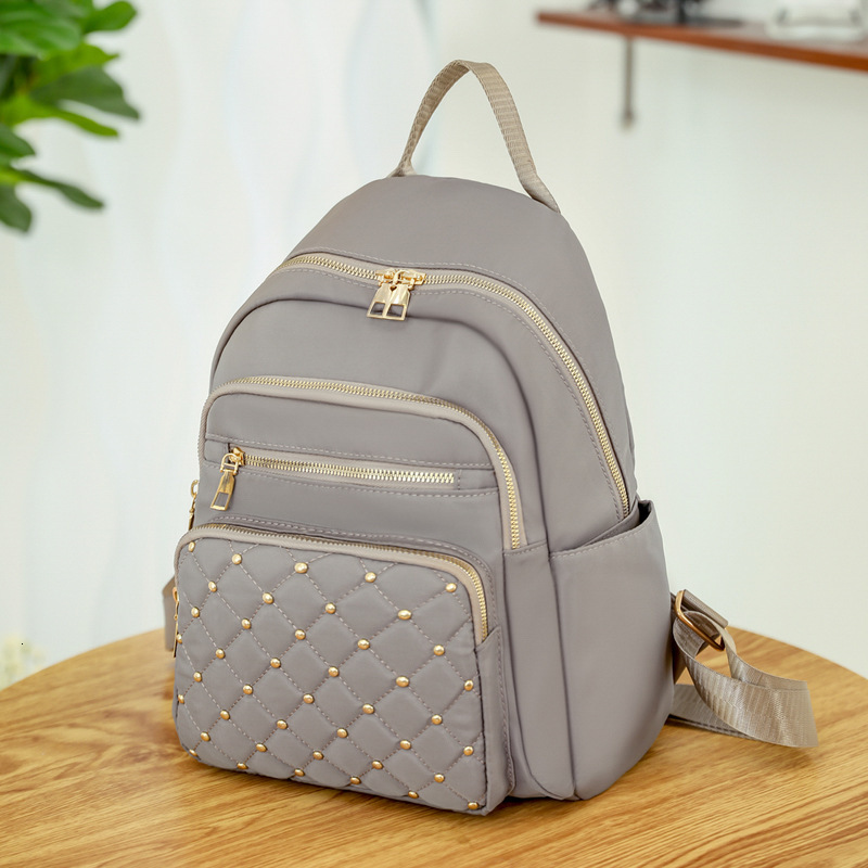 2025 Texture Rivet Backpack Large Capacity Simple Women s Diamond Grid Fashion Designer Summer Backpack New Outdoor Leisure Storage Bag Wallet Handbag