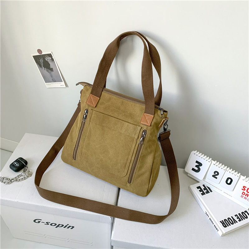 Leisure backpack Commuter Handheld One Shoulder Crossbody Trendy Women's Large Capacity Multi compartment Canvas designer bag