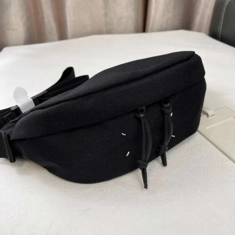 Unique and trendy black nylon crossbody bag for both men and women featuring a niche original and fashionable waist bag 250318