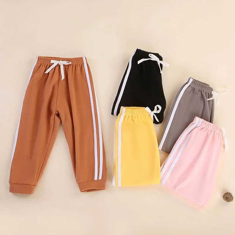 Childrens solid color sports pants for boys and girls spring and autumn casual sports clown pants elastic waist pantsT250318