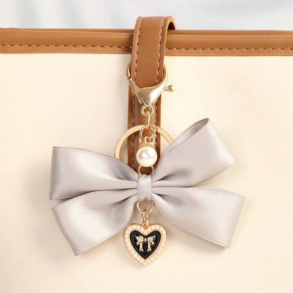 New fabric ribbon bow keychain fashionable heart-shaped pearl pendant womens customized keychain hanging rope car keychain bag accessoriesXJ250319