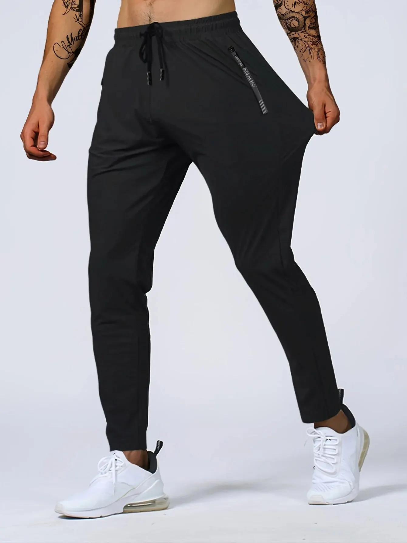Mens fast drying breathable waist dragging and jogging pants fashionable high elasticity sports 250320