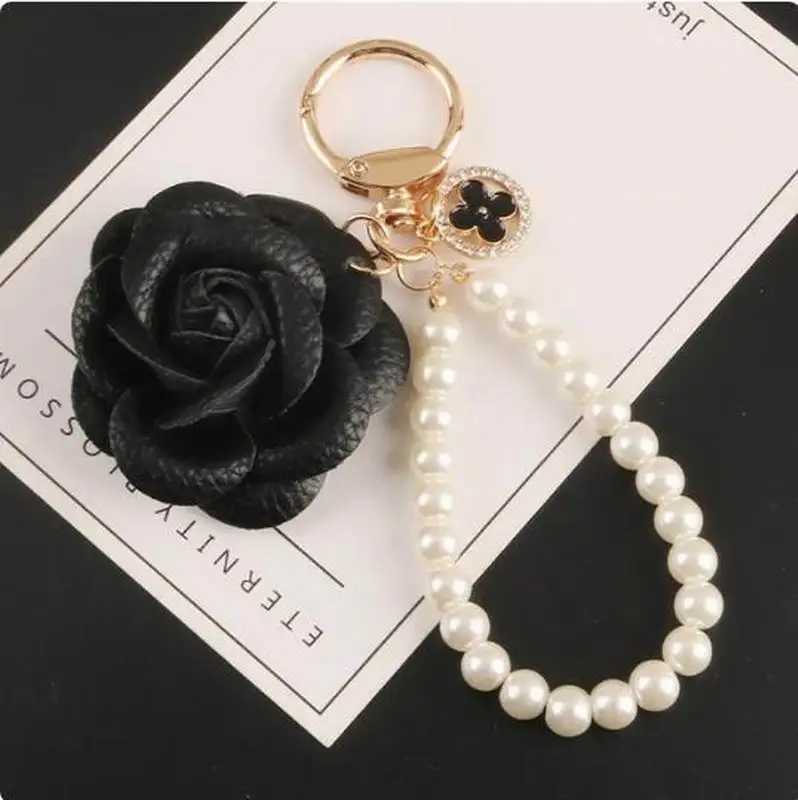 Cute synthetic PU leather rose camellia keychain suitable for women tripod keychain circular car bag pendant charm D467XJ250319