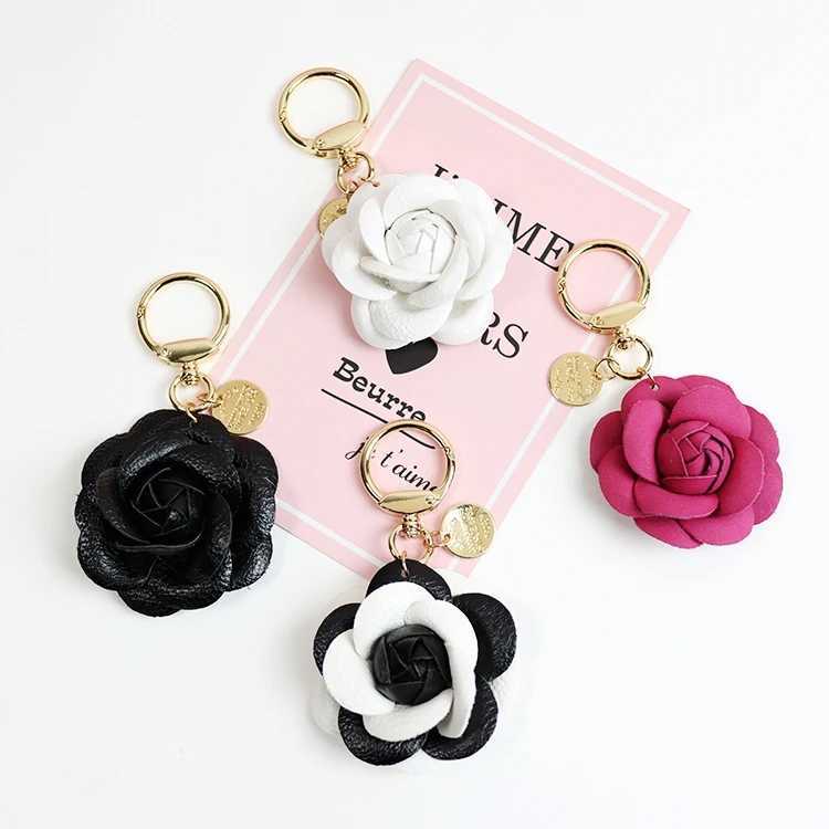 Cute synthetic PU leather rose camellia keychain suitable for women tripod keychain circular car bag pendant charm D467XJ250319