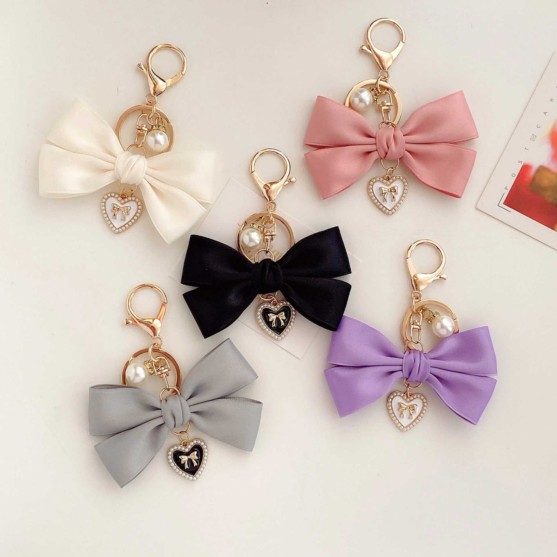 New fabric ribbon bow keychain fashionable heart-shaped pearl pendant womens customized keychain hanging rope car keychain bag accessoriesXJ250319