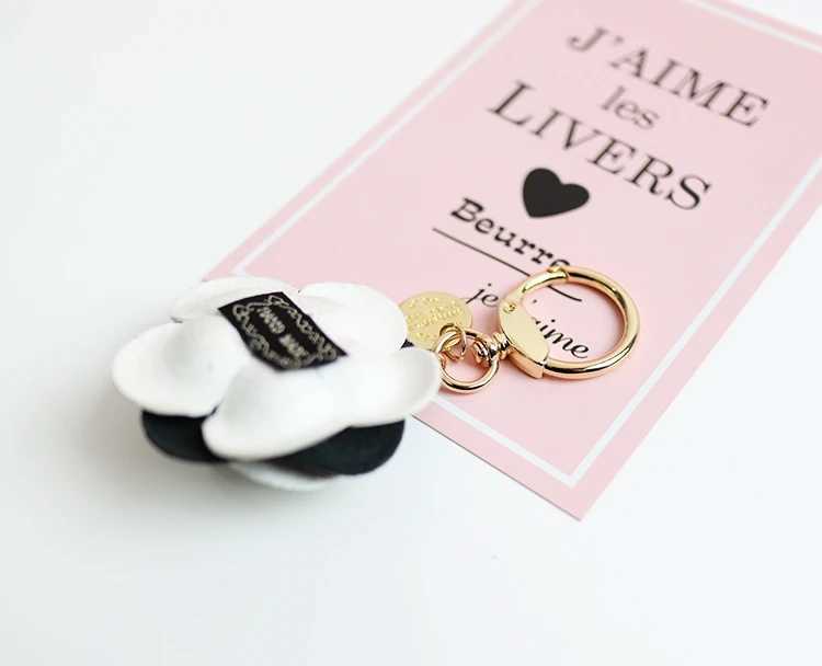 Cute synthetic PU leather rose camellia keychain suitable for women tripod keychain circular car bag pendant charm D467XJ250319