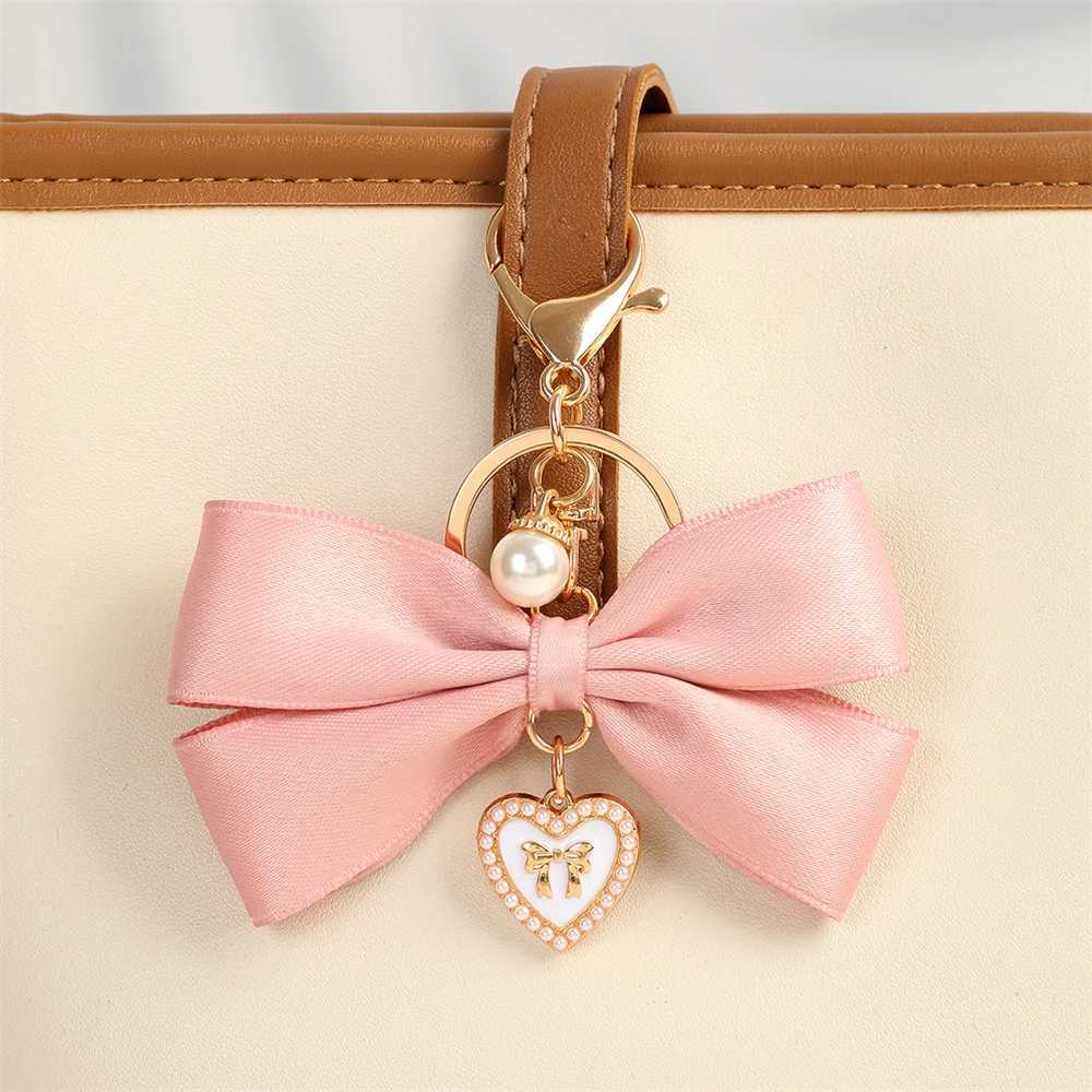 New fabric ribbon bow keychain fashionable heart-shaped pearl pendant womens customized keychain hanging rope car keychain bag accessoriesXJ250319