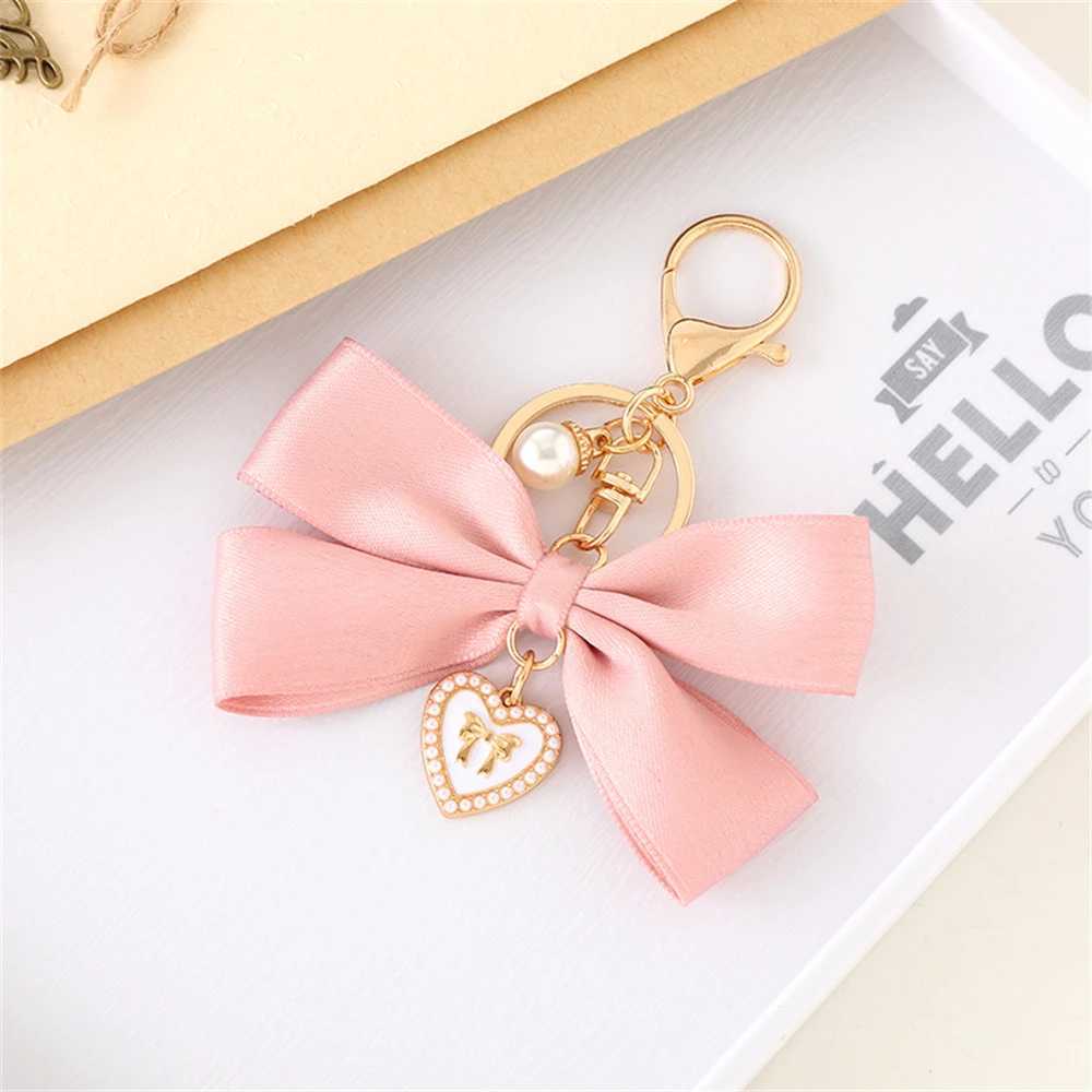 New fabric ribbon bow keychain fashionable heart-shaped pearl pendant womens customized keychain hanging rope car keychain bag accessoriesXJ250319