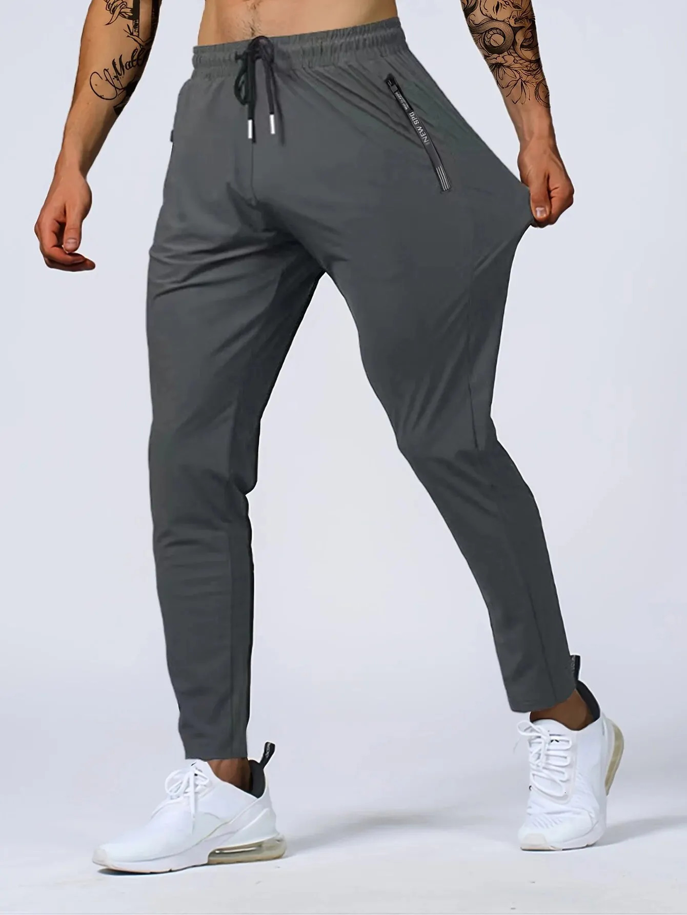 Mens fast drying breathable waist dragging and jogging pants fashionable high elasticity sports 250320
