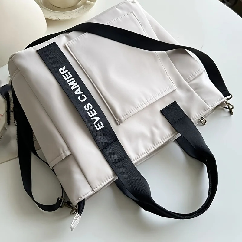 EVEs camera multi pocket handbag with adjustable shoulder strap zipper closure perfect for school work travel or daily use 250320