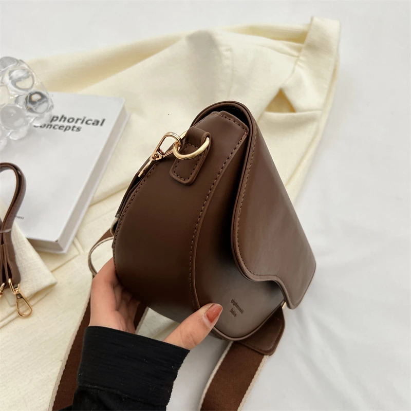 Womens retro solid color flip small saddle shoulder and lower arm bag fashionable PU leather wide strap horizontal 250320