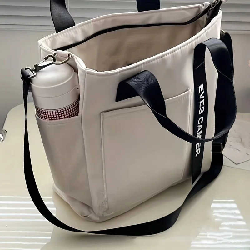 EVEs camera multi pocket handbag with adjustable shoulder strap zipper closure perfect for school work travel or daily use 250320