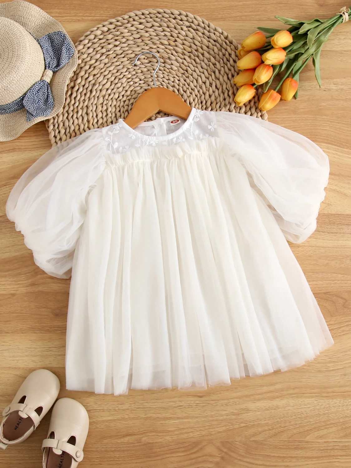 The charming girl Par is wearing a chic fluffy sleeve dress made of sheer fabric perfect for birthday celebrations and childrens dresses W250326