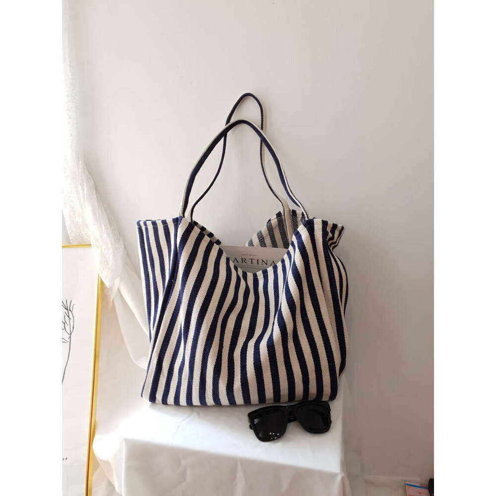 Korean version of artistic handbag, simple fresh, striped canvas bag, versatile and casual, large capacity single shoulder women's bag