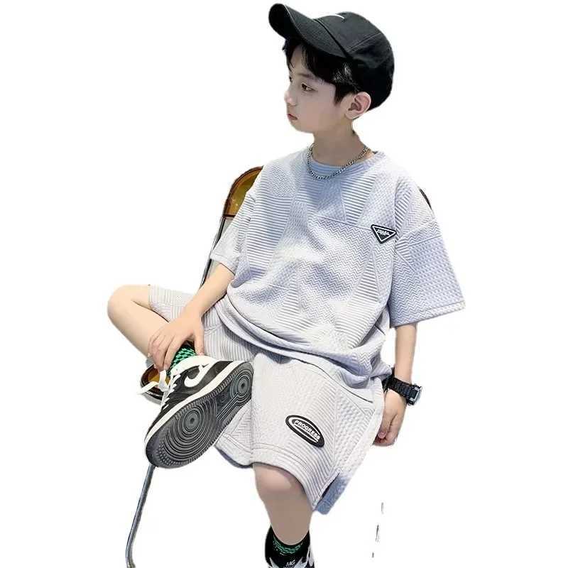 Provide childrens track and field clothing for ages 7 to 16 featuring a simple round neck design short sleeved top and loose shortsT250327