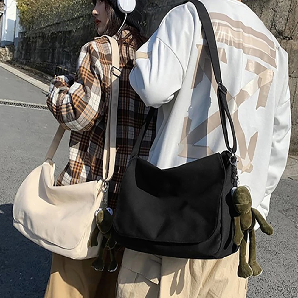 Fashion canvas cross shaped youth bag shoulder womens casual large organizer outdoor messenger with pendant for men 250326