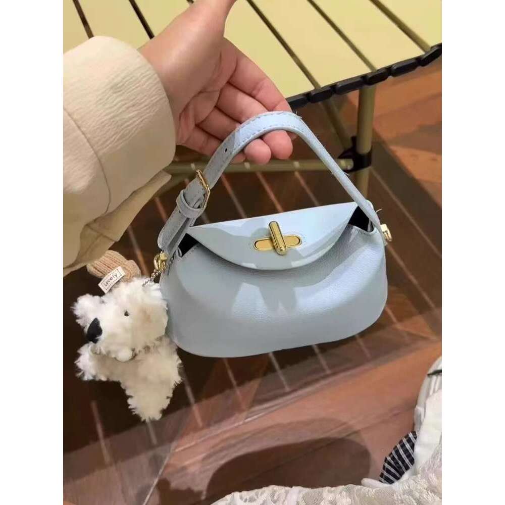 Small and cute western-style hand-held yuanbao 2025 summer new lock bag, dopamine small fresh crossbody bag